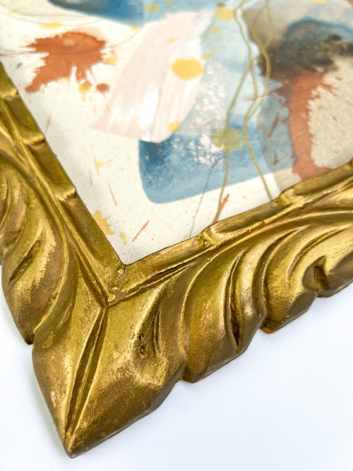 Close-up of a decorative gold frame with a textured surface