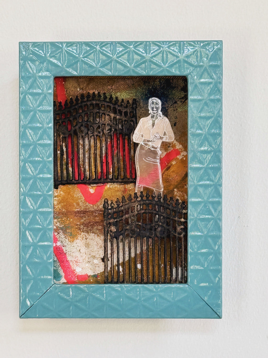 Framed artwork with a woman and gate design on a textured background