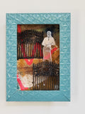 Framed artwork with a woman and gate design on a textured background