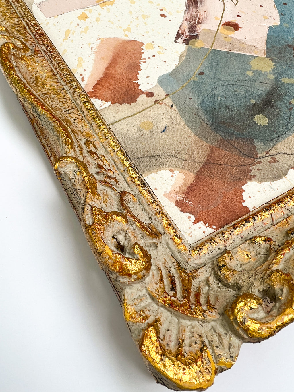 Decorative mirror with gold frame and watercolor background