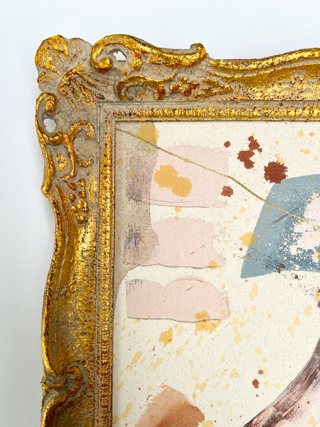 Decorative gold frame with a textured, multicolored background