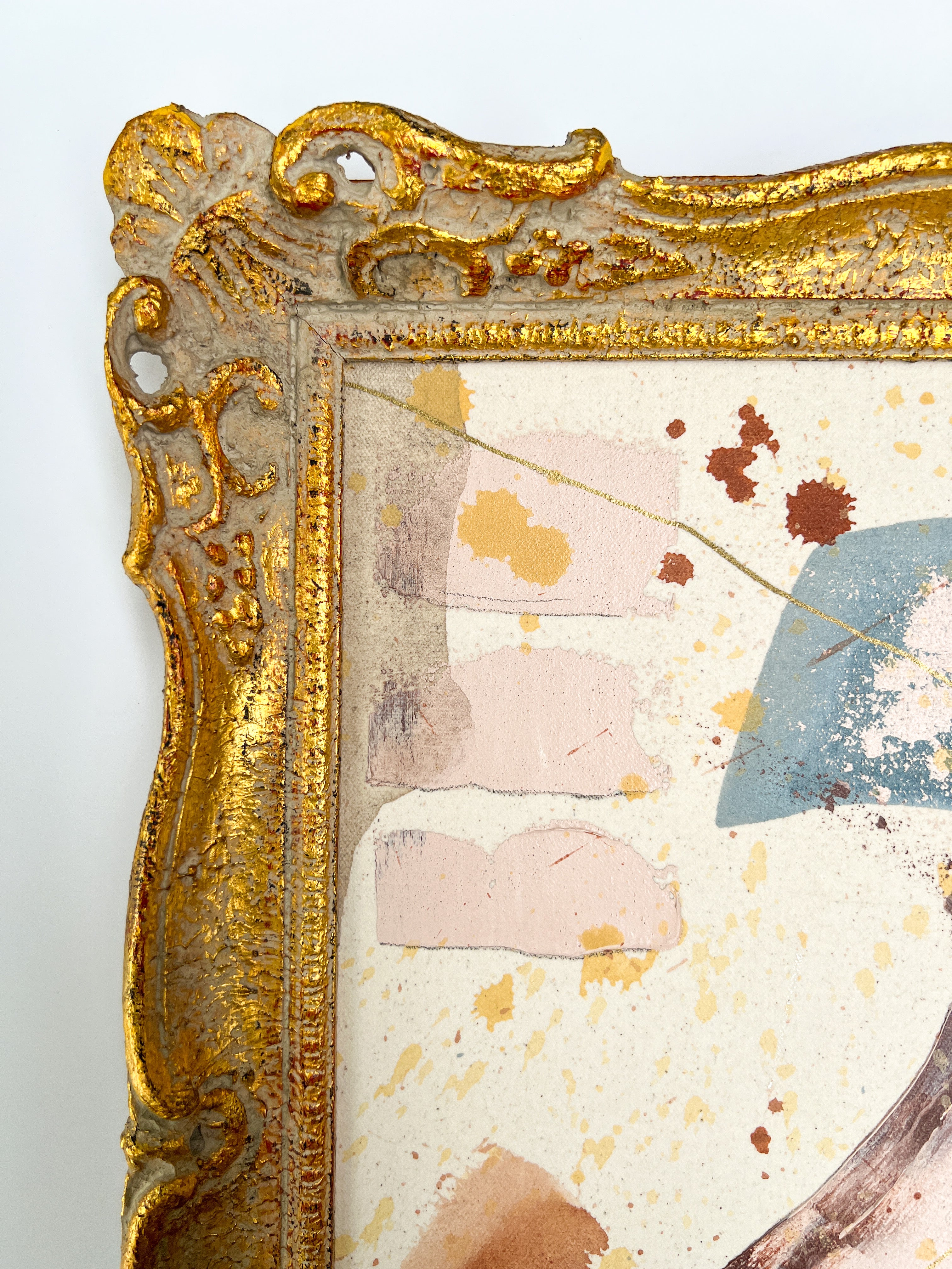 Decorative gold frame with a textured, multicolored background