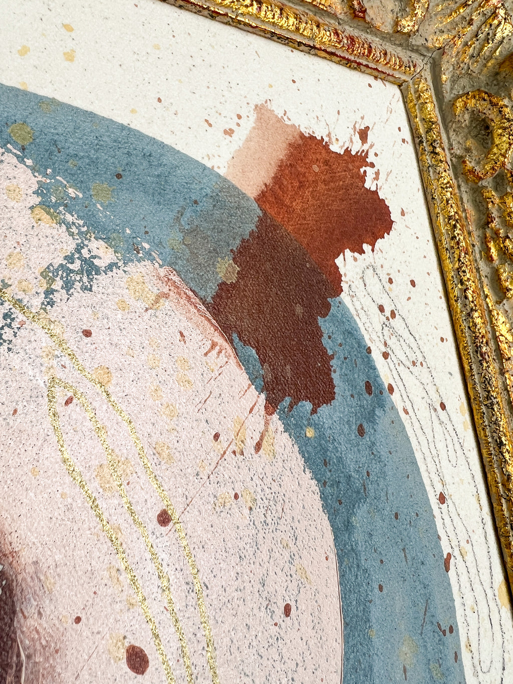 Close-up of a textured surface with gold and blue patterns