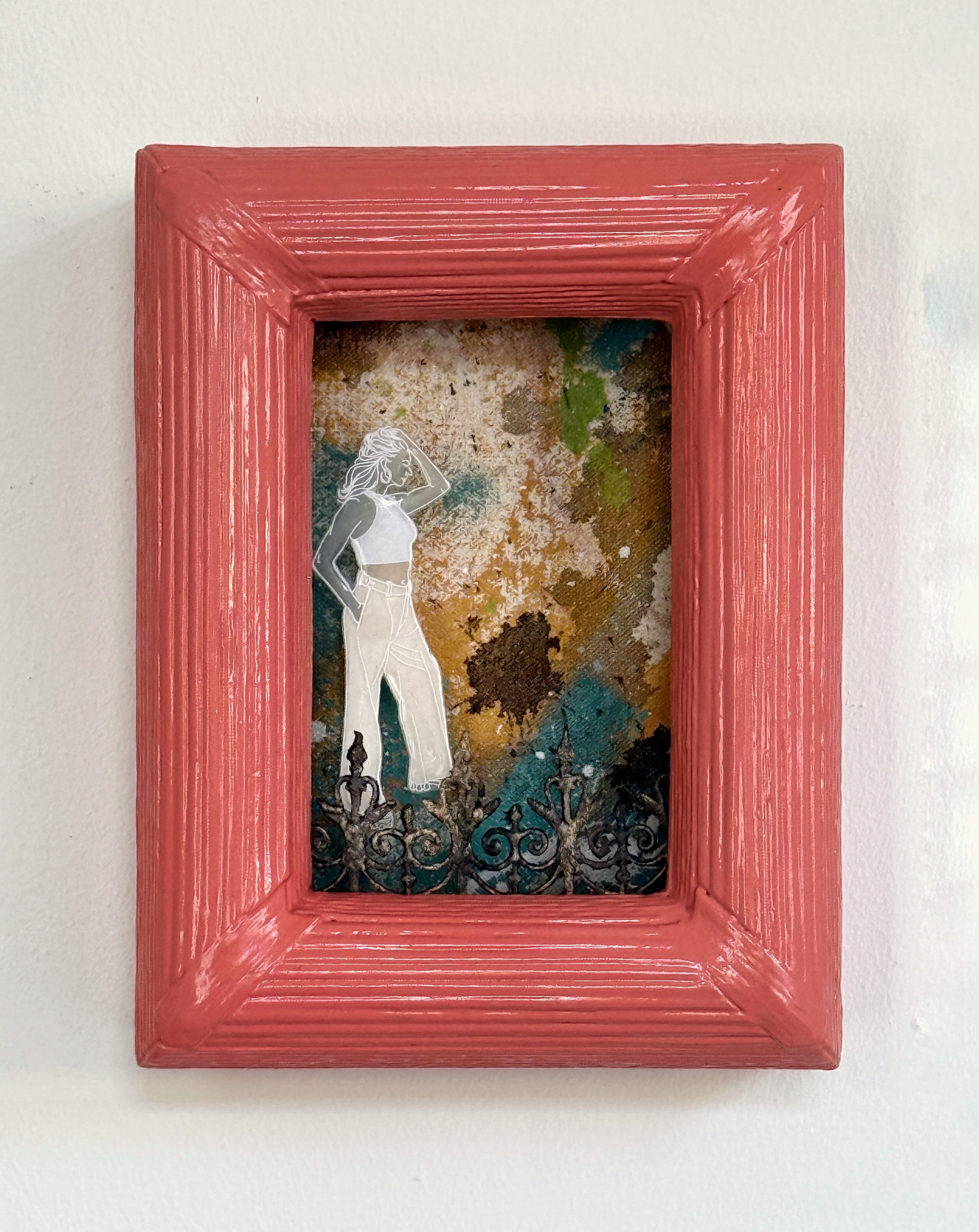 Framed artwork with a colorful background and a figure inside, on a light gray background