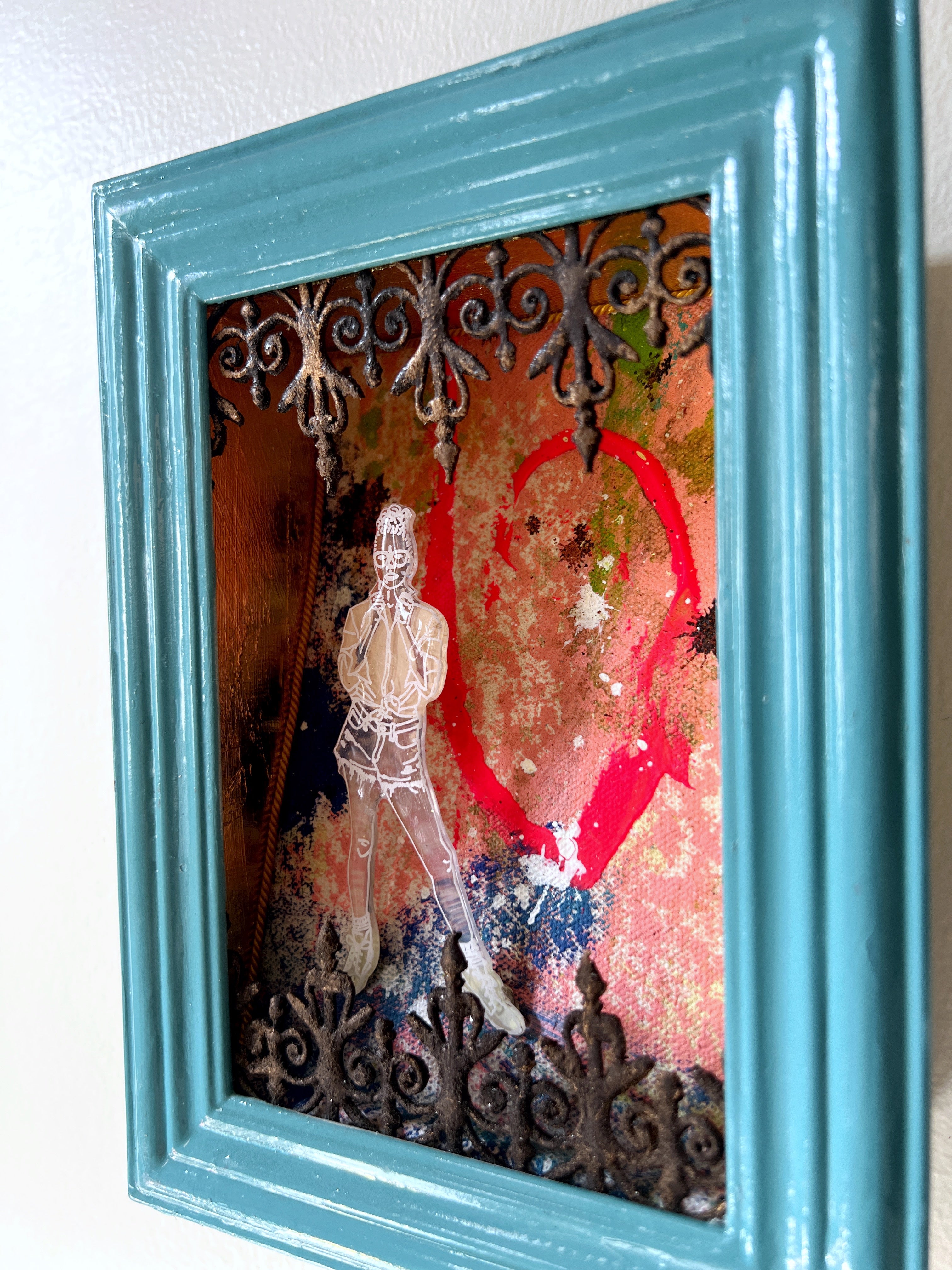 Artistic depiction of a figure with a red heart in a teal frame
