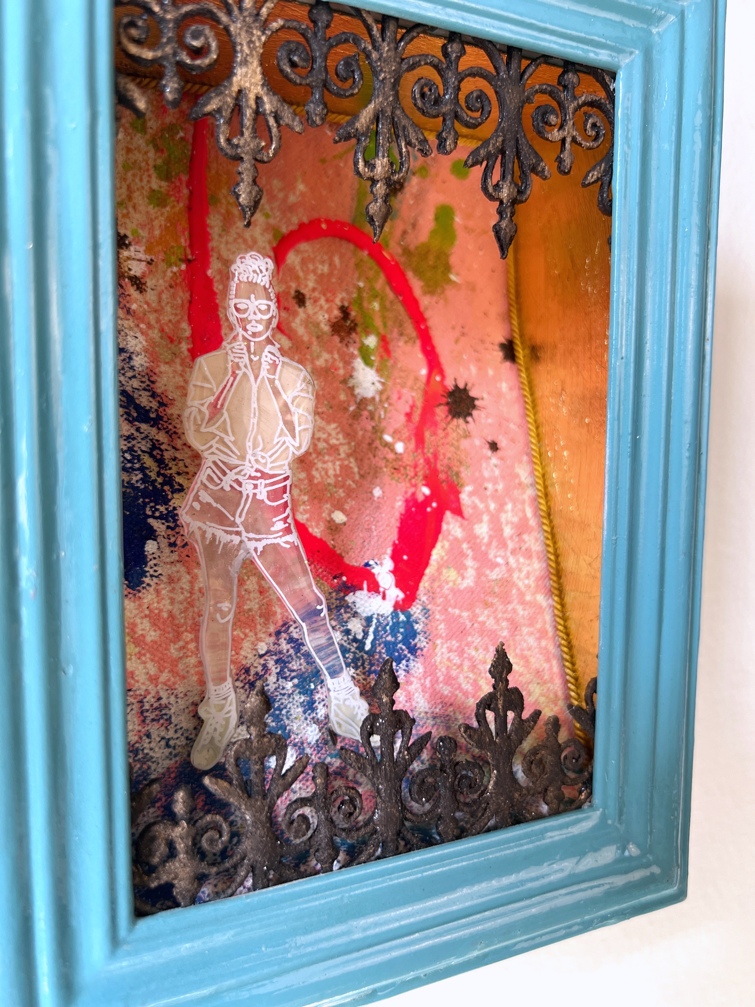 Framed artwork with a woman's silhouette and decorative elements on a textured background.