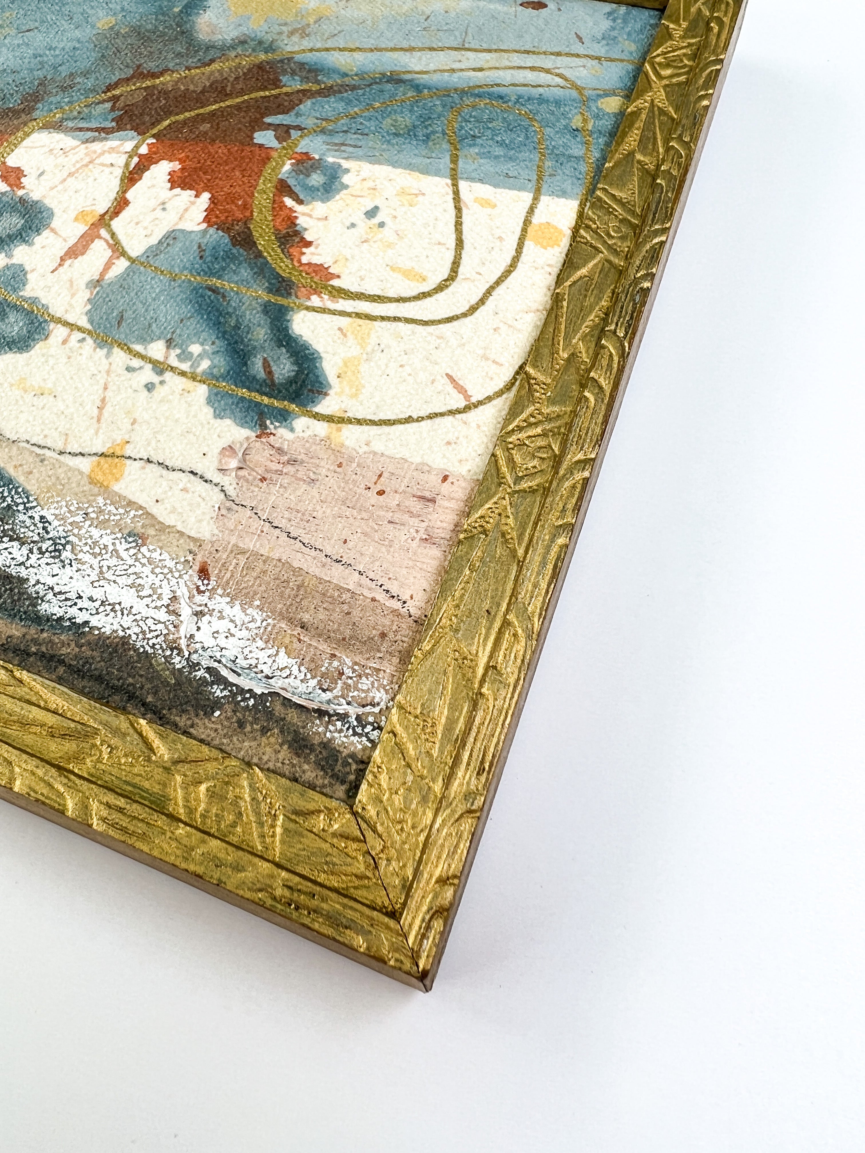 Artistic depiction of a landscape with abstract elements on a textured surface, in a vintage gold frame.