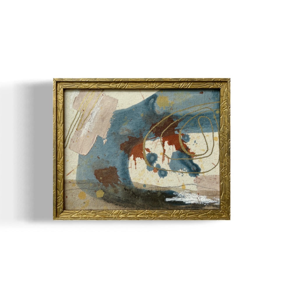 Framed abstract painting with gold frame on a white background