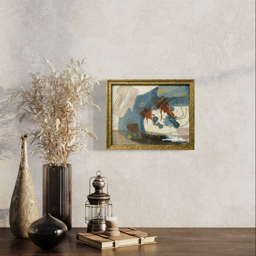 Framed abstract painting on a wall with decorative vases and lantern on a table.